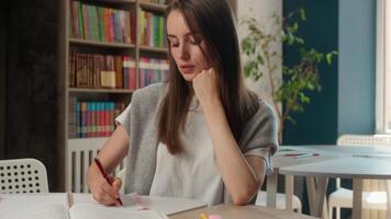Caucasian woman businesswoman classroom library teacher student girl study learning writing notebook notes exam preparation female business indoor education university high school lesson write course video