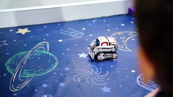 Slow motion of small robot interacting on space-themed surface video