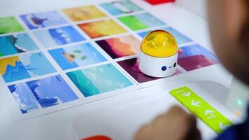 Engineer programming educational robot using visual cards in slow motion video