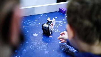 Child playing with programmable robot toy in slow motion video