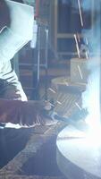 A Skilled Expert Welder at Work in a Busy Industrial Setting Focusing on High Quality Craftsmanship. Stock Clip video