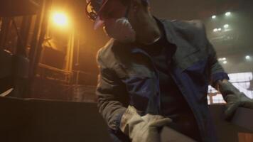 A worker efficiently completing tasks in an industrial setting while wearing safety gear. Stock Clip video