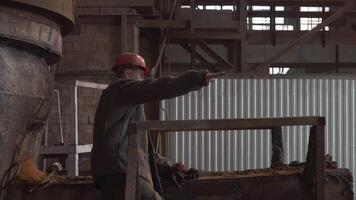 An Industrial Worker Devotedly Operating Complex Machinery in an Active Workshop Environment. Stock Clip video