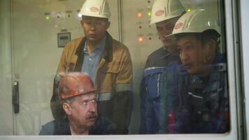 Industrial workers monitor operations from the control room, ensuring smooth and safe protocols. Stock Clip video