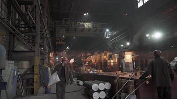 A busy production workshop scene with workers collaborating efficiently with machinery and tools. Stock Clip video