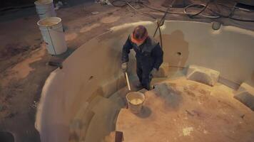 A Dedicated Construction Worker Skillfully Applying a Smooth Finish in a Circular Tank. Stock Clip video