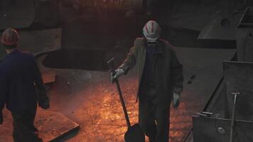 Workers in a foundry are engaged in the careful handling of molten metal at high temperatures. Stock Clip video