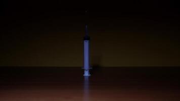 Syringe on the table on dark background video
