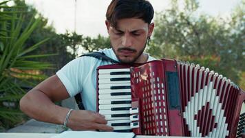 Man Studying Accordion And Watching On The Paper video