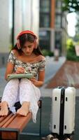 A Young Girl Enjoying Sketching While Listening to Music through Headphones in an Urban Setting video