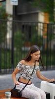 A traveler takes a break for relaxation in a lively city, enjoying the moment fully video