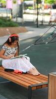 A young girl is savoring the joy of reading a book while immersed in the beauty of nature video