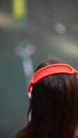 A child happily wearing noisecanceling headphones while exploring an urban environment video