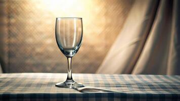 A glass on a light table, on an illuminated background with a curtain video