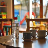 A table with two cups and a bottle of water photo