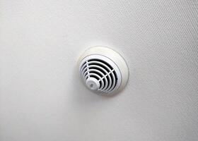 Modern Smoke Detector on Textured Wall for Home Safety photo
