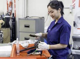 Asian woman industrial engineer wearing uniform working in industrial workshop. photo