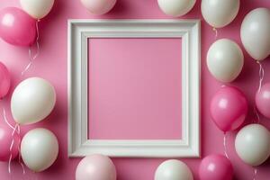 Colorful pink and white balloons and an empty frame arranged on a wall for a festive celebration inviting photo