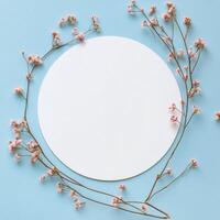 Floral arrangement with circular space on light blue background for creative design or artistic presentation photo