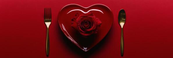 Romantic dinner setting with red heart shaped dessert and rose on a plate in warm lighting photo