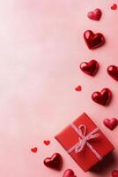 Gift box wrapped in red ribbon surrounded by red hearts and rose petals on a pink background creating a festive photo