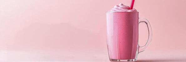 Delicious pink smoothie topped with fresh raspberries served in a clear glass mug against a pastel background photo