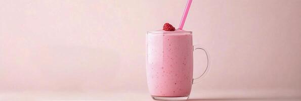 Delicious pink smoothie topped with fresh raspberries served in a clear glass mug against a pastel background photo