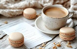 Coffee cup rests next to macaroons and scattered coffee beans on a cozy knit blanket during a leisurely photo