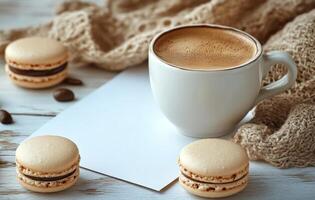 Coffee cup rests next to macaroons and scattered coffee beans on a cozy knit blanket during a leisurely photo