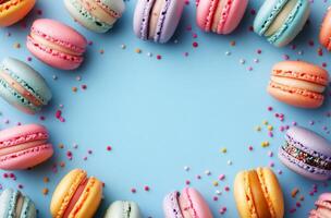 Colorful macarons arranged in a circular pattern on a light blue surface with sprinkles highlighting a playful photo