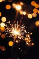 Sparkler shines brightly in a dark night, illuminating the festive atmosphere with glowing sparks and a magical photo