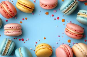 Colorful macarons arranged in a circular pattern on a light blue surface with sprinkles highlighting a playful photo
