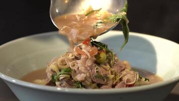 Close up to boiled and fried Pork Thai Menu with Shrimp Paste in white bowl that ready to serve and eat. video