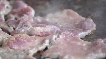 Close up to Pork necks are being grilled on large cooker grill. video