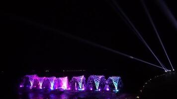 Waterworks at the night on the water surface, decorated and played color by lighting spot light. video