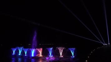 Timelapse of Waterworks at the night on the water surface, decorated and played color by lighting spot light. video