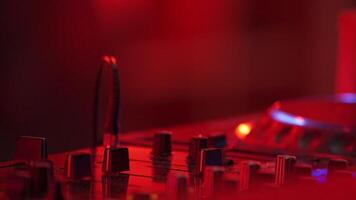 DJ hand and finger are closed up between he controls the Mixer Sound Console board Machine. video