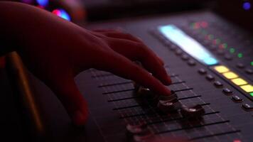 DJ hand and finger are closed up between he controls the Mixer Sound Console board Machine. video