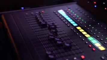 DJ hand and finger are closed up between he controls the Mixer Sound Console board Machine. video