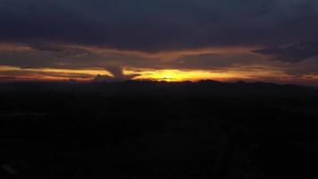 Senset moment view from drone behind the mountain in the golden light from the sun. video