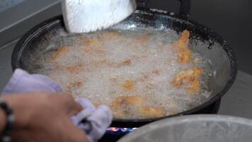 The Deep Fried chicken wings are Deeping fried in the boiling oil in the pan. video