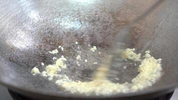 Fried Garlic cubes slices in the pan on gas stove video