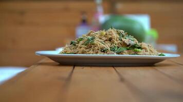 Stir fried noodle and pork with preserved soy bean paste on the wood counter food and ready fo lunch video