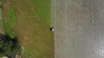 top view of a agriculture vehicle machine transplant rice seedling in a paddy field in the open sky day from drone view. video