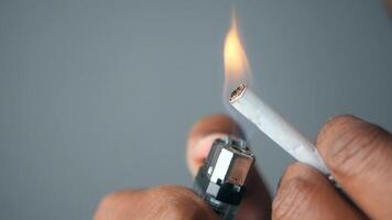 A CloseUp View of Igniting a Cigarette with a Lighter in Detail video