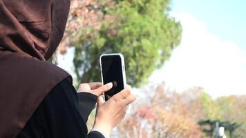 Capturing Moments. A Person Taking Photos Outdoors with Smartphone video