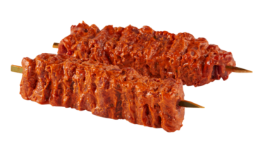 Pork coated in red sauce on skewers cut out isolated transparent background png