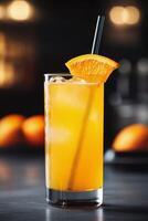 Refreshing beverage served in glass with orange slice and ice on dark background photo