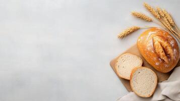 Freshly baked bread loaves arranged on a wooden cutting board with slices visible photo