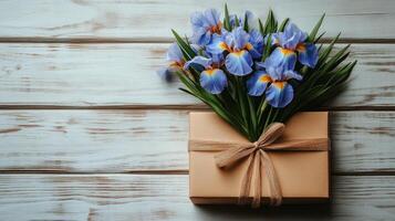 Beautiful bouquet of iris flowers in a simple vase on a rustic table photo